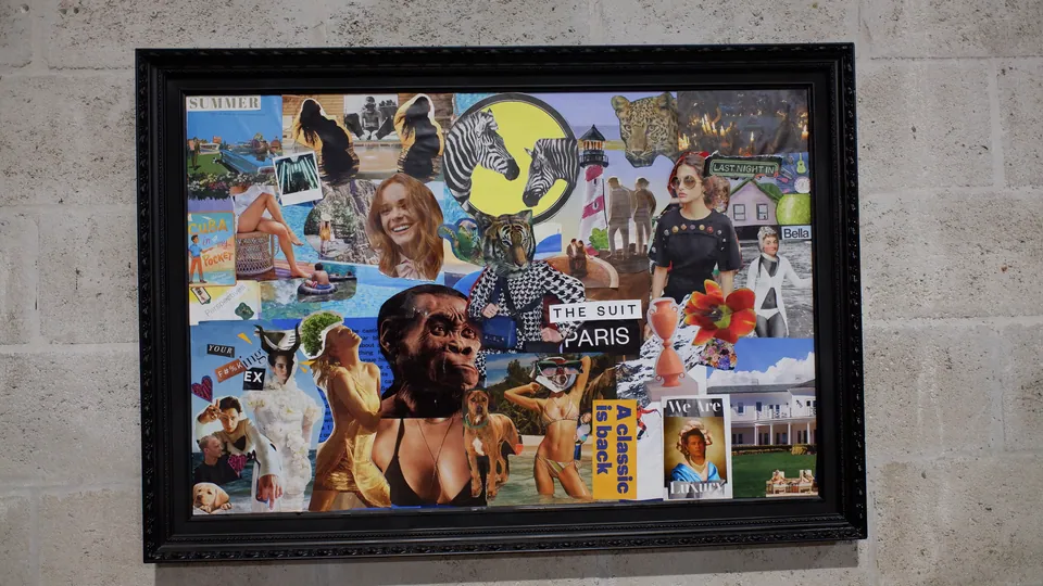 Wide collage in a carved black frame on a pale block wall, packed with magazine cut-outs: zebras, a tiger in a suit, a lighthouse, bathers.